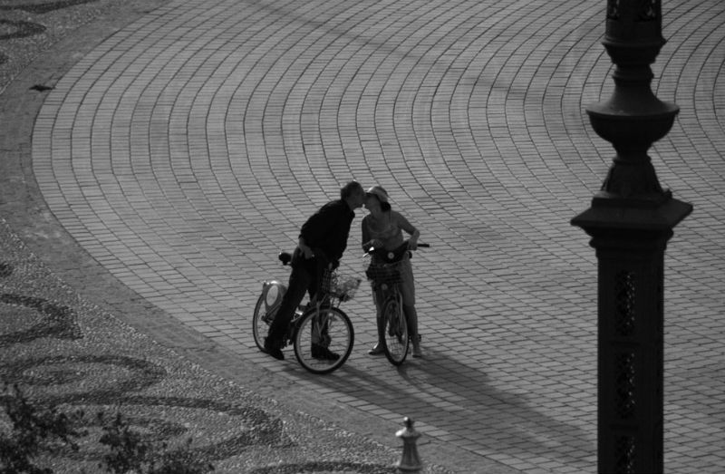 自転車に乗ったままキスするカップル
