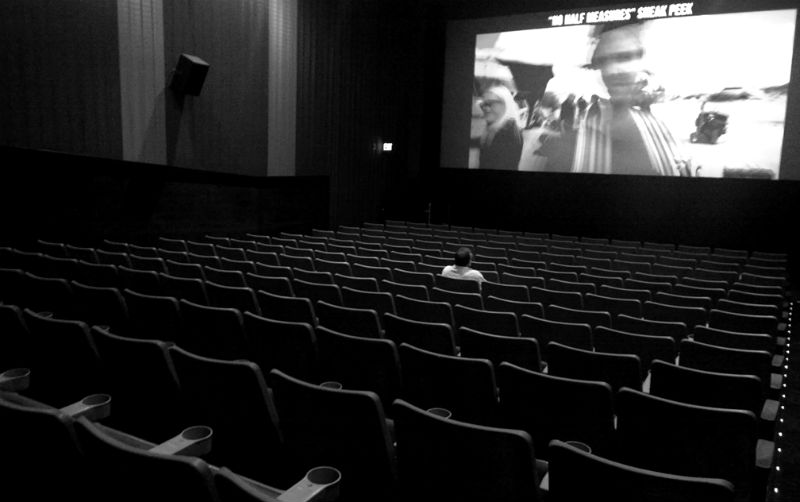 １人で映画を観る青年